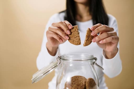 Woman who broke free from the restrict-binge cycle having a cookie